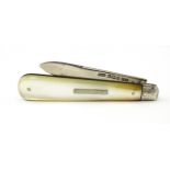 A silver folding fruit knife with mother of pearl handle, hallmarked Sheffield 1914, maker John