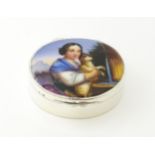 A silver pill box with gilded interior and ceramic cabochon to lid depicting a young girl holding