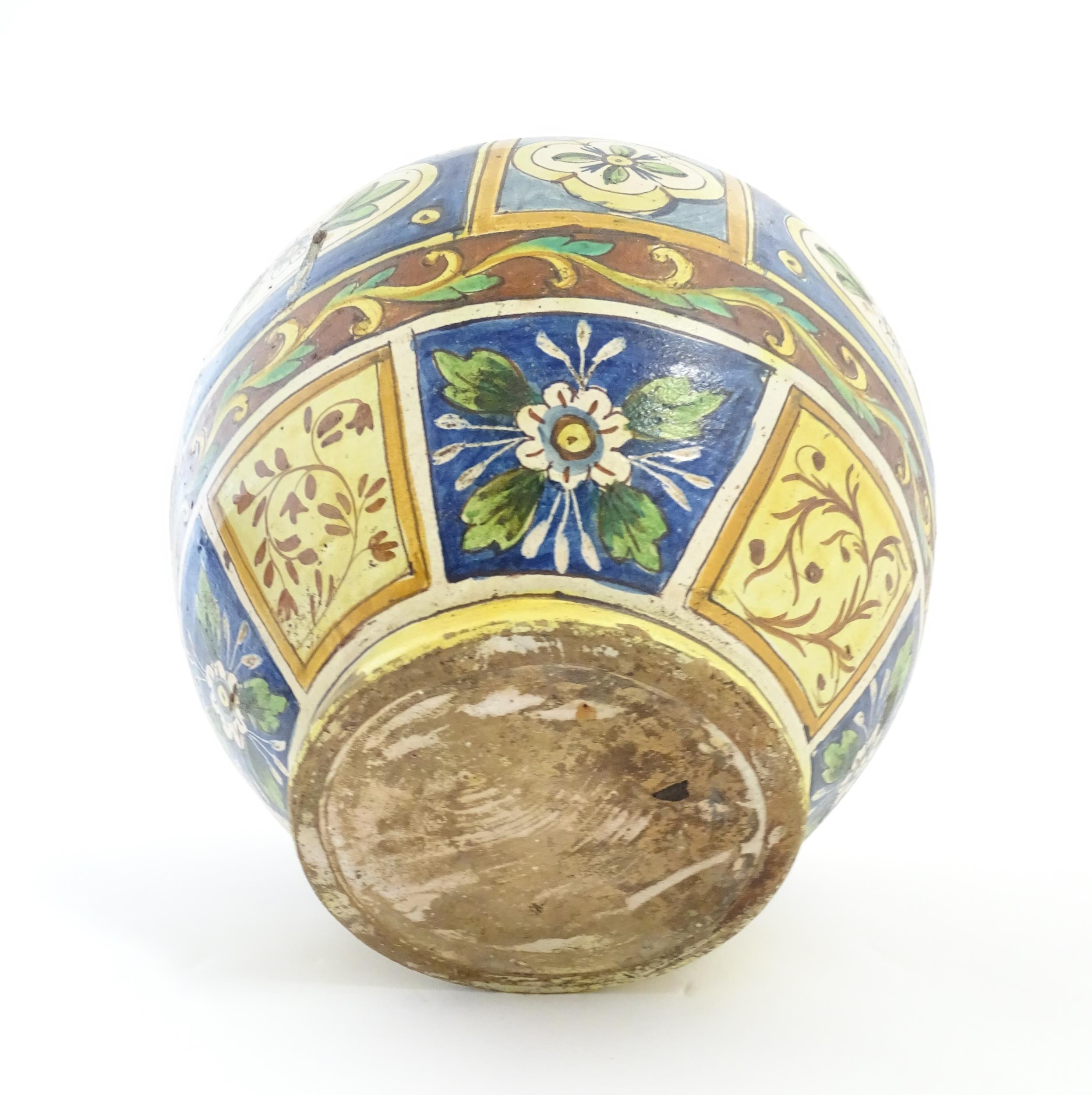 A Sicilian maiolica Bombola vase with panelled and banded decoration depicting flowers and - Image 2 of 10