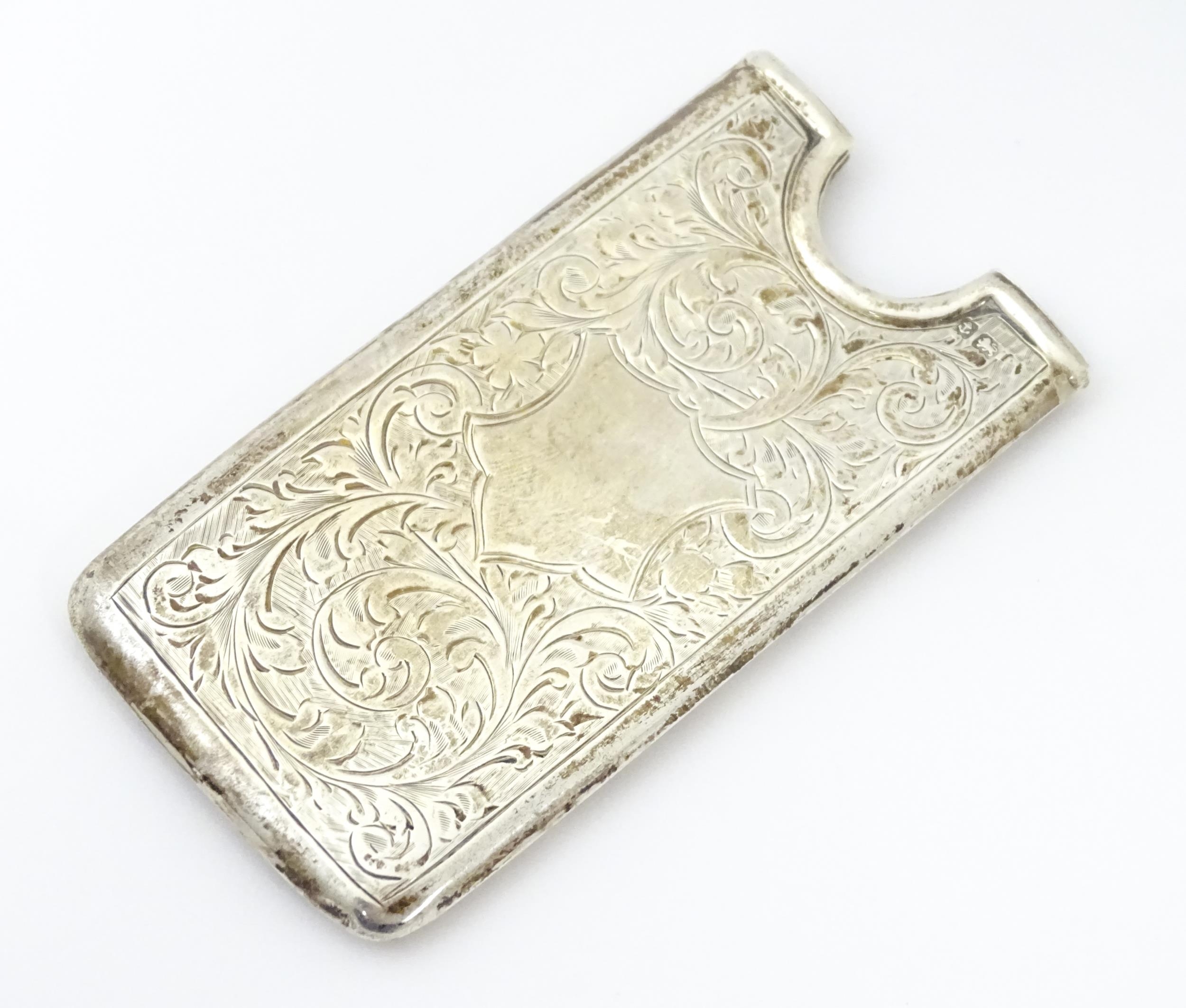 A silver card case with engraved decoration, hallmarked Birmingham c. 1906, maker George Bowen &
