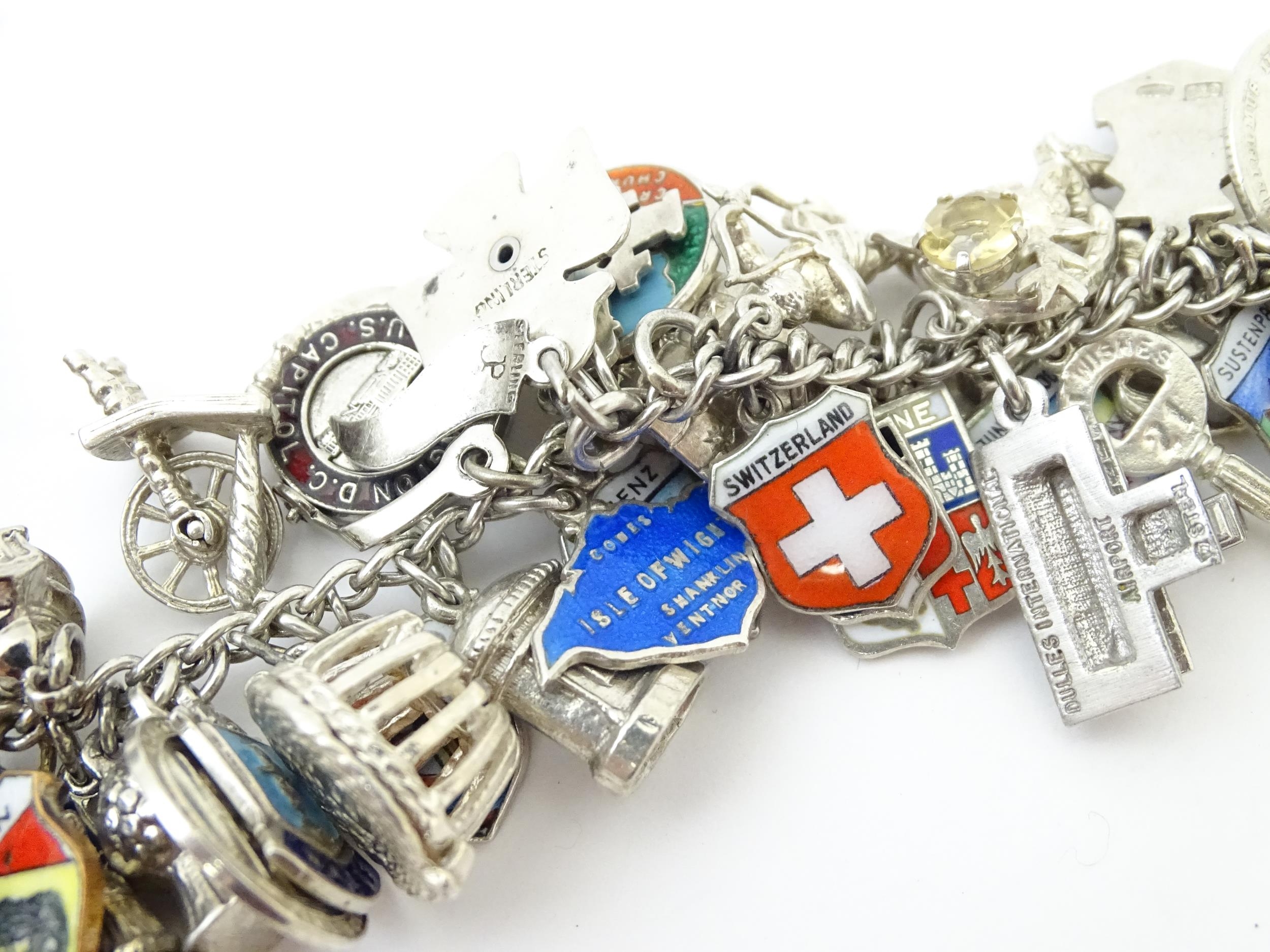A silver charm bracelet set with various silver, white metal and silver plate charms Please Note - - Image 5 of 8