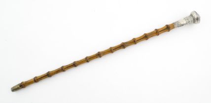 A late 19th / early 20thC swagger stick with white metal detail to pommel with punchwork