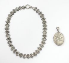 A Victorian silver locket with engraved bird decoration together with a chain marked Sterling. The