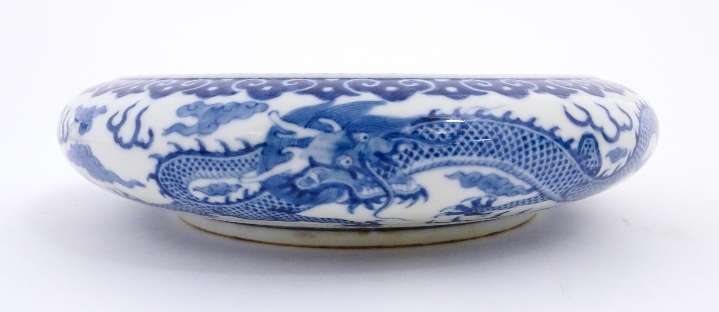 A Chinese blue and white dish decorated with dragons amidst clouds. Character marks under. Approx. - Image 6 of 8