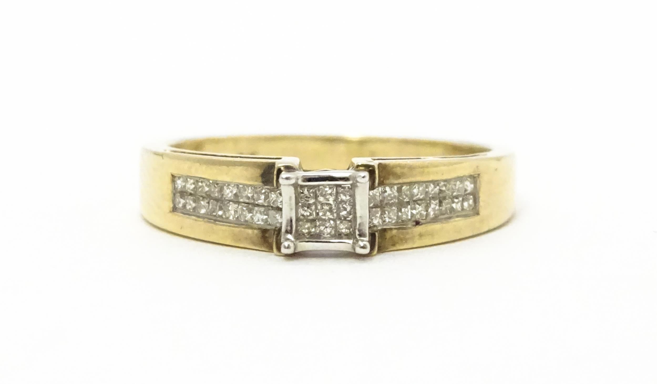 A 9ct gold ring set with 9 central diamonds flanked by a further 14 diamonds to each shoulder. - Image 3 of 8