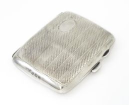 A silver cigarette case opening to reveal faux tortoiseshell lining within. Hallmarked Birmingham