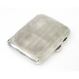 A silver cigarette case opening to reveal faux tortoiseshell lining within. Hallmarked Birmingham