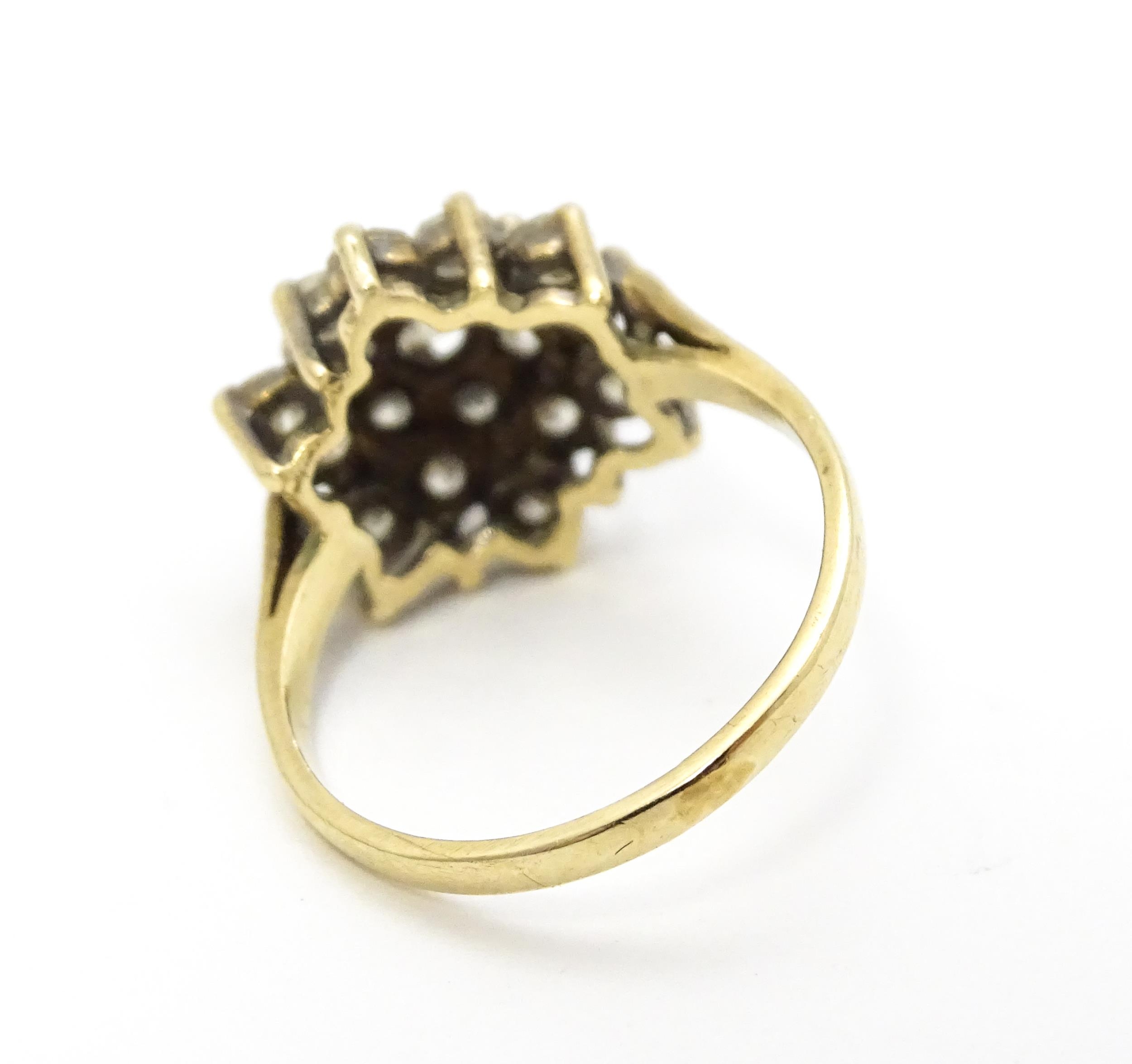 A 9ct gold ring set with diamonds in a floral cluster setting. Ring size approx. M Please Note - - Image 7 of 8