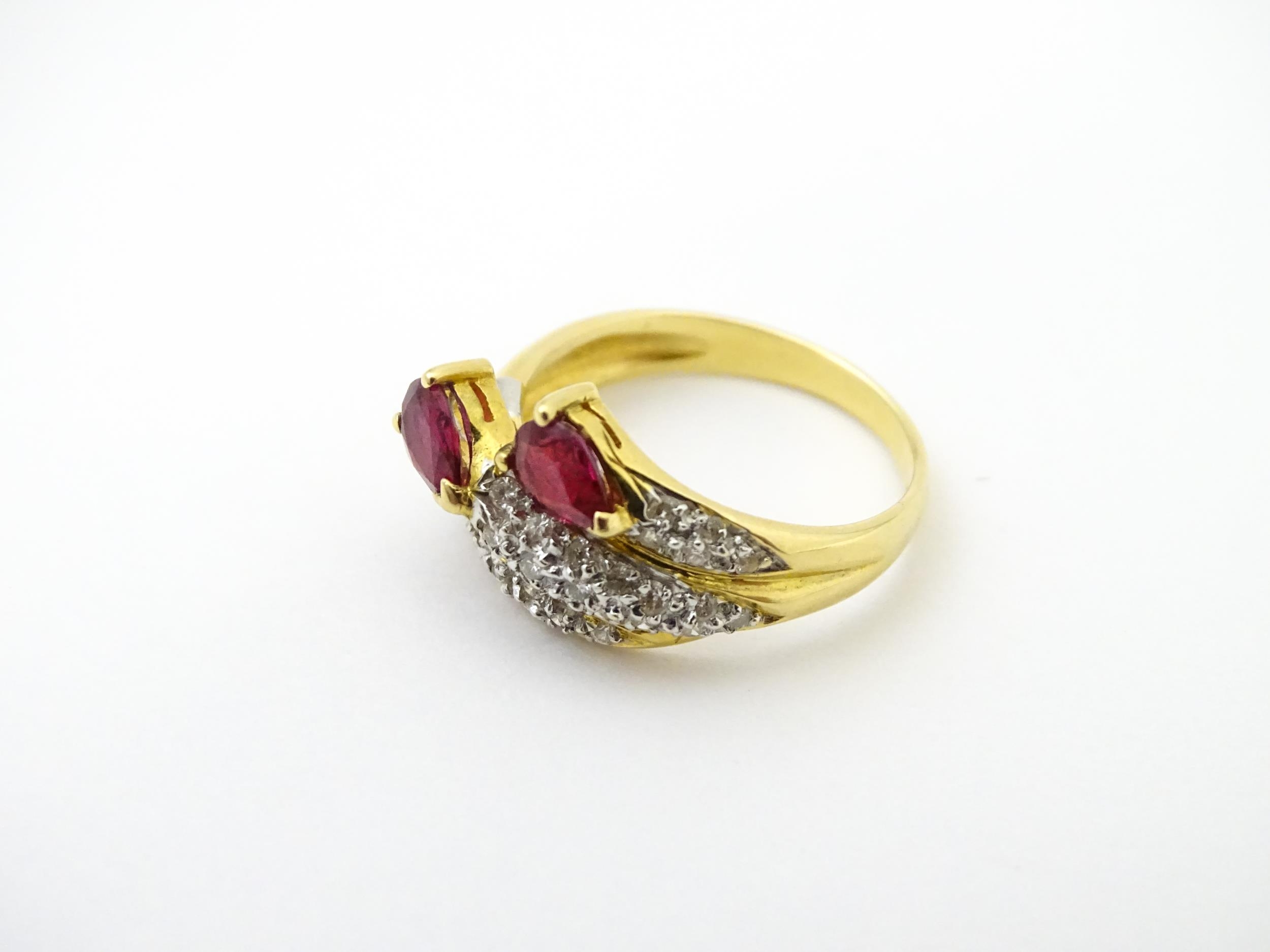 An 18ct gold ruby and diamond ring set with two rubies and a profusion of diamonds. Ring size - Image 4 of 6