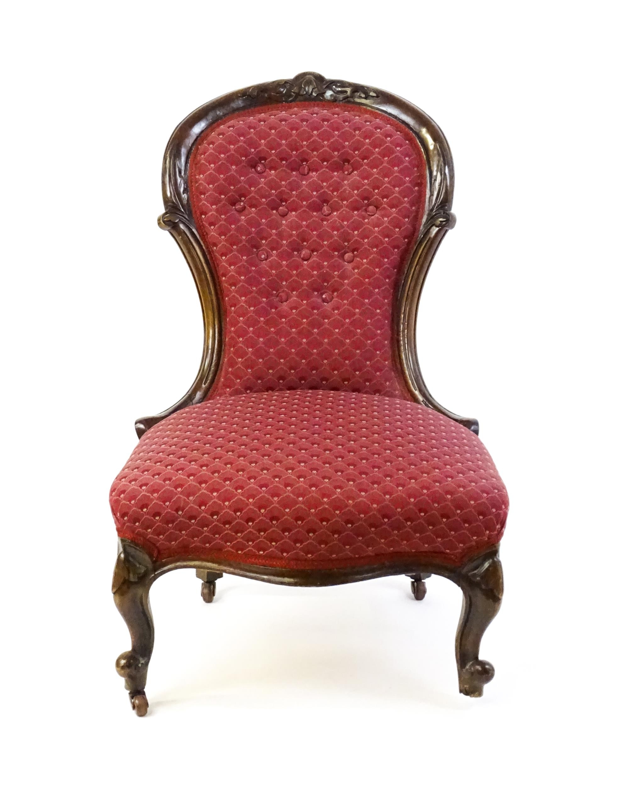 A late 19thC / early 20thC nursing chair with a deep buttoned spoon back adorned with a carved - Image 5 of 7