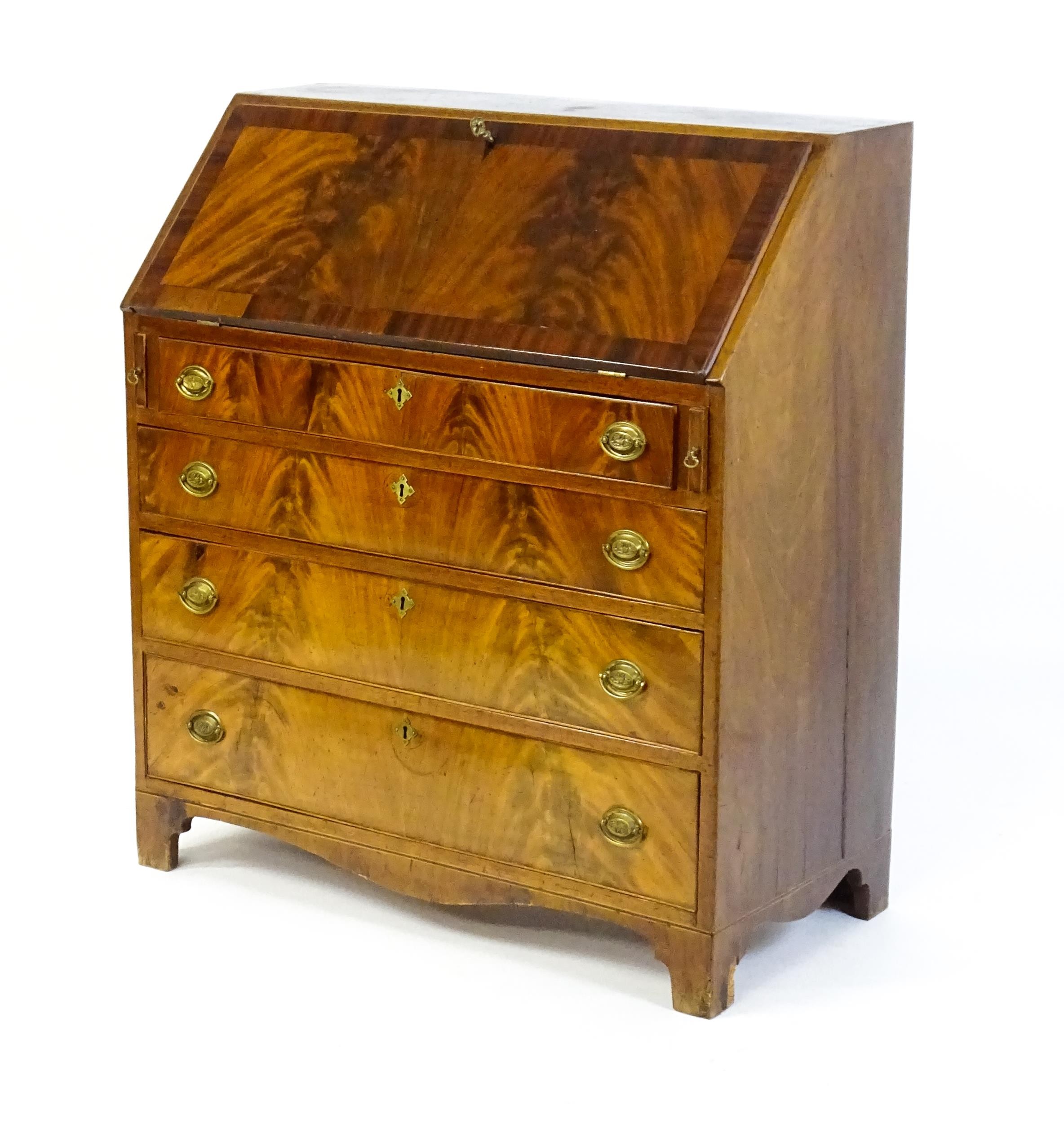 An early 19thC mahogany bureau with a fall front above four long graduated drawers with brass back - Image 5 of 6