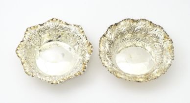 A pair of silver bonbon dishes with embossed decoration hallmarked Sheffield 1904 / 1905, maker