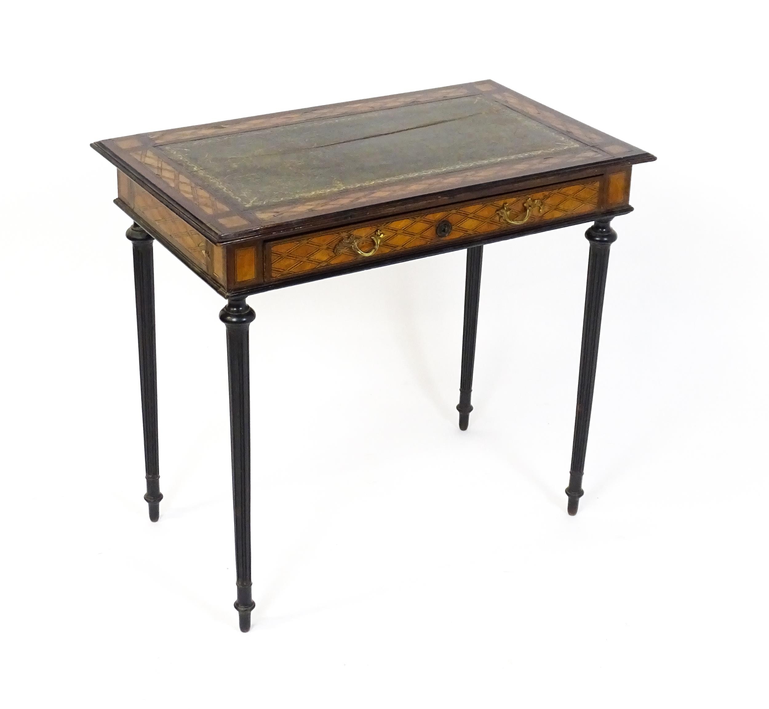 A 19thC side table with a satinwood inlaid top enclosing a gold tooled green leather top above a