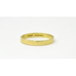 An 18ct gold ring / wedding band. Ring size approx. O Please Note - we do not make reference to