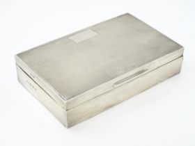 A silver table top cigarette box with engine turned decoration hallmarked Birmingham 1961, maker