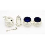 A matched four piece silver cruet set comprising pepper, mustard with spoon and two salts with