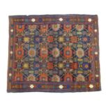 Carpet / Rug: A blue ground rug decorated with repeating geometric motifs of stylised floral and