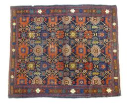 Carpet / Rug: A blue ground rug decorated with repeating geometric motifs of stylised floral and