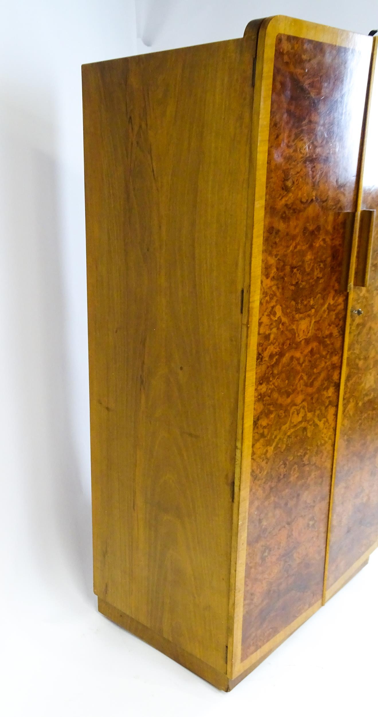 A mid 20thC Art Deco style wardrobe / cupboard with burr walnut veneered doors and shaped handles. - Image 7 of 7