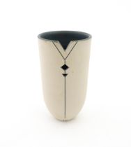 A studio pottery vase by Louise Darby with pierced geometric detail. Signed with impressed