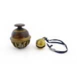 An Indian brass elephant claw bell. Together with a crotal bell marked AD and HN. Claw bell