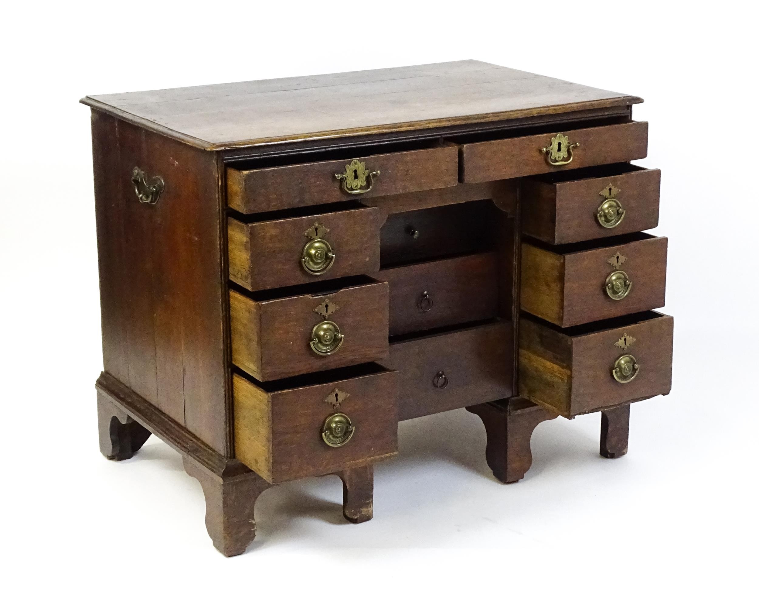 An early / mid 18thC oak kneehole desk with a moulded top above two short drawers and two banks of - Image 2 of 10