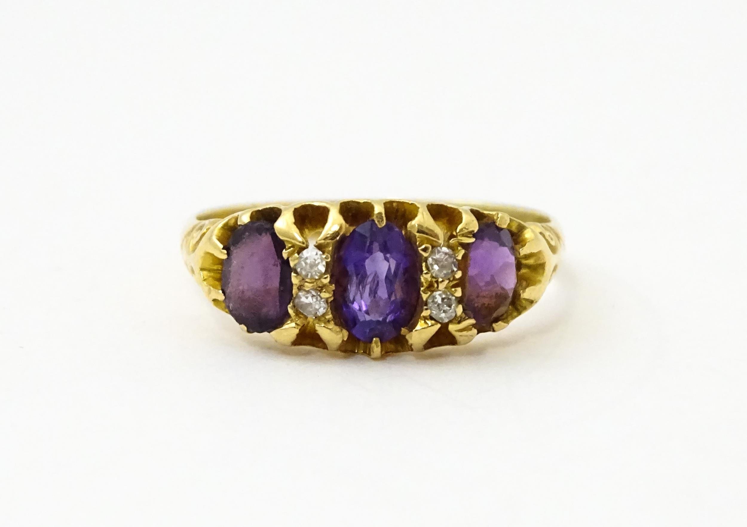 An 18ct gold ring set three graduated amethyst and four diamonds. Ring size approx. Q Please - Image 3 of 7