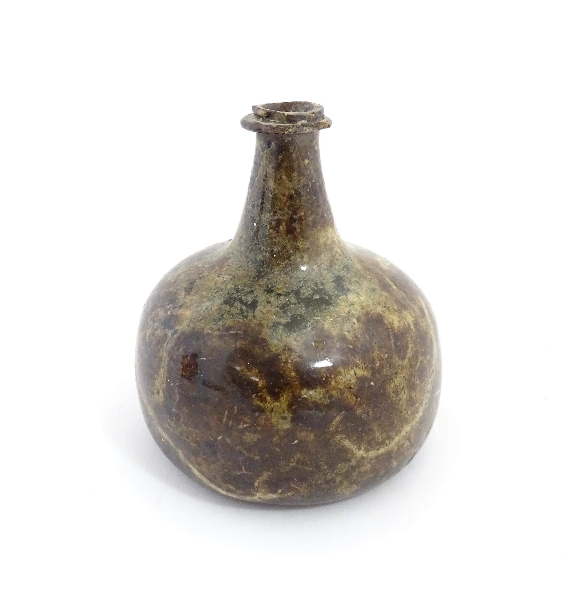 A late 18thC / early 19thC English dark olive green glass onion shape wine bottle. Approx. 6" high - Image 4 of 6