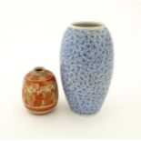 An Oriental blue and white vase of ovoid form decorated with scrolling foliage. Together with a