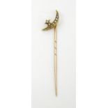 A yellow metal stick pin surmounted by crescent moon and star set with seed pearls. Approx. 2 1/2"