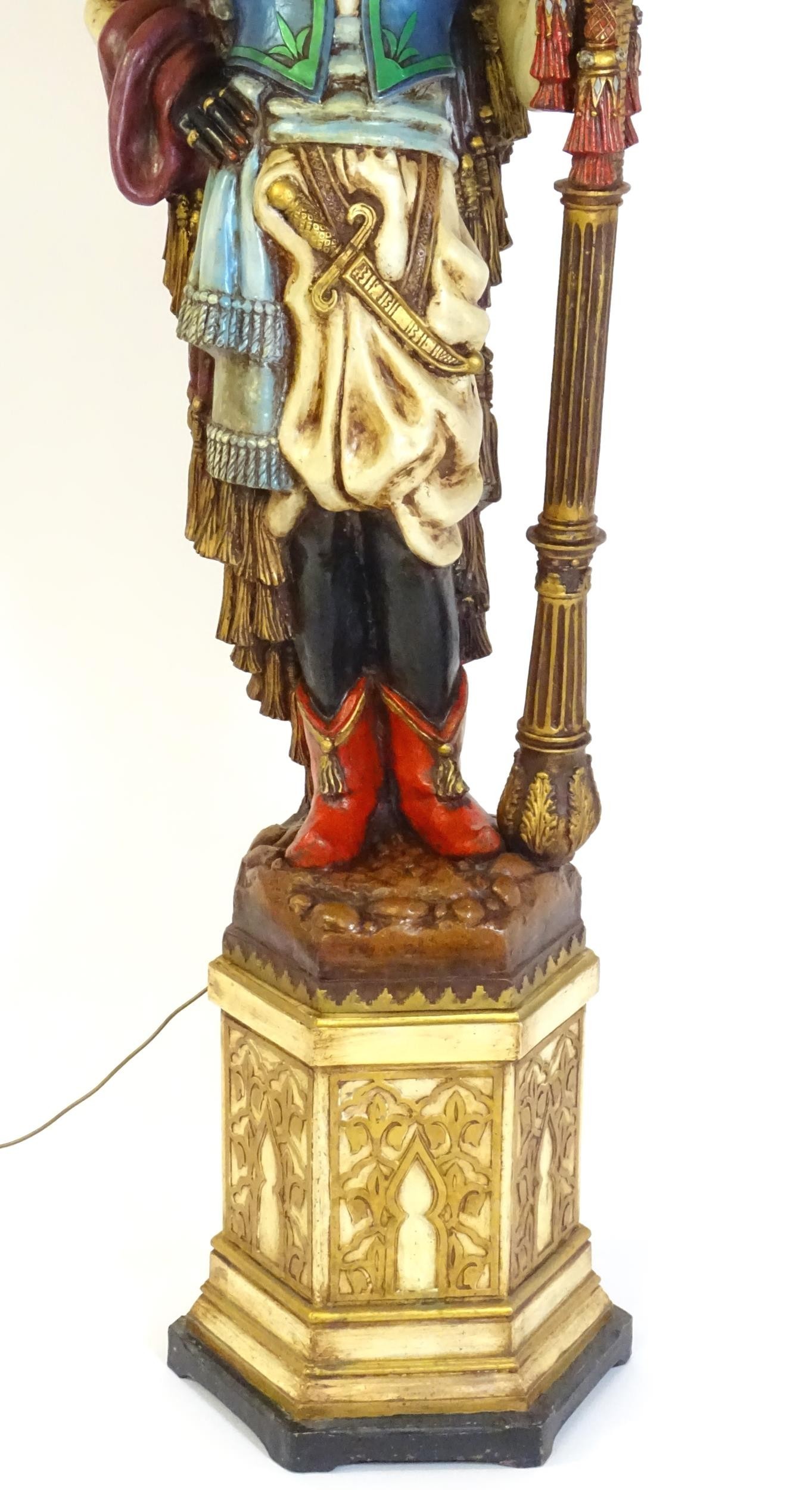 A mid 20thC blackamoor lamp, the lamp having a polychrome figural top grasping a torchiere, the - Image 6 of 14