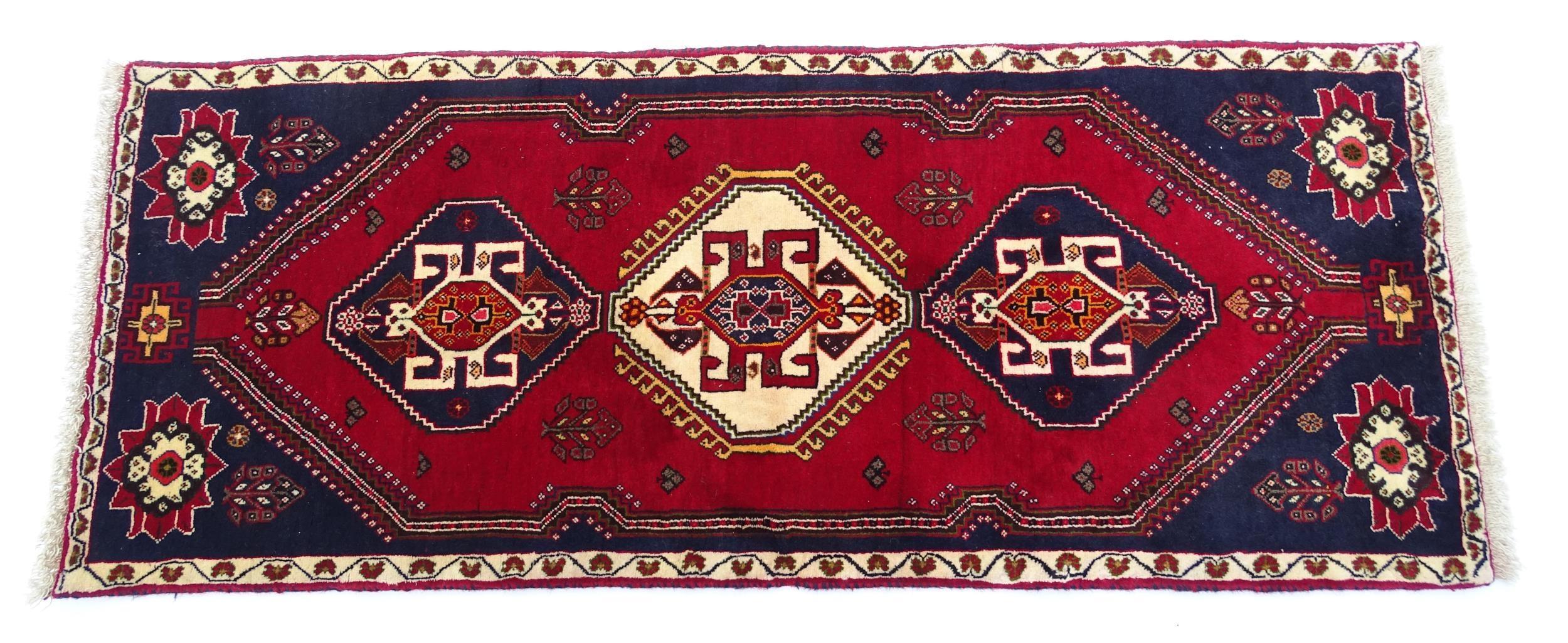 Carpet / Rug: A South West Persian qashgai runner, the red and blue ground with central geometric