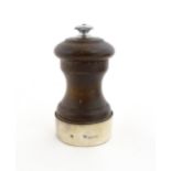 A 20thC turned wooden pepper mill / grinder with silver mount hallmarked Birmingham 1969, maker J.