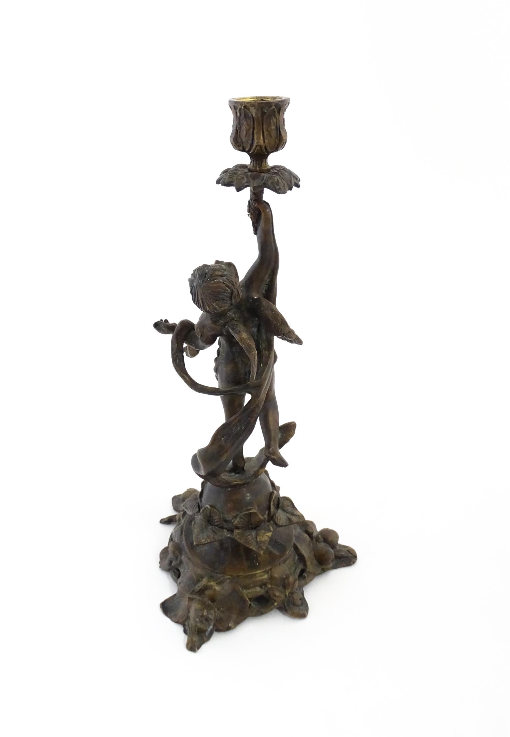 An early 20thC cast candlestick modelled as a winged putto / cherub holding aloft a sconce with - Image 5 of 6