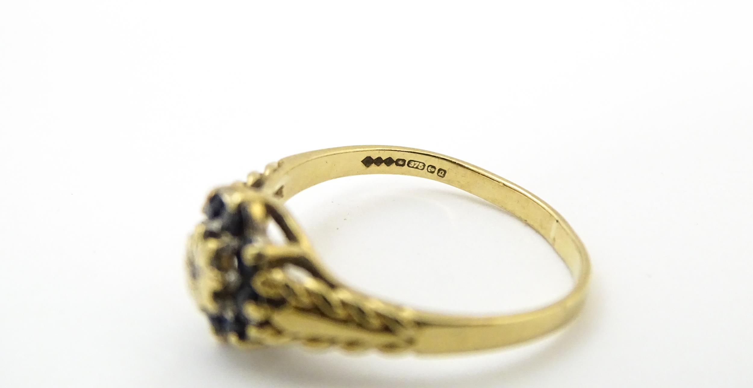 A 9ct gold ring set with central diamond bordered by sapphires. Ring size approx. M Please Note - we - Image 2 of 8