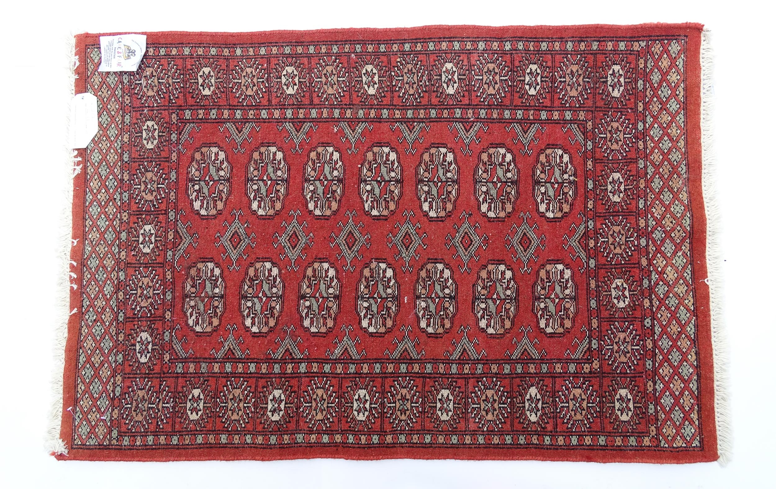 Carpet / Rug : A Pakistan wool red ground rug decorated with repeating geometric motifs with further - Image 8 of 8