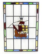 A 20thC stained glass panel depicting a sailing ship with flag. Approx. 33" x 22" Please Note - we