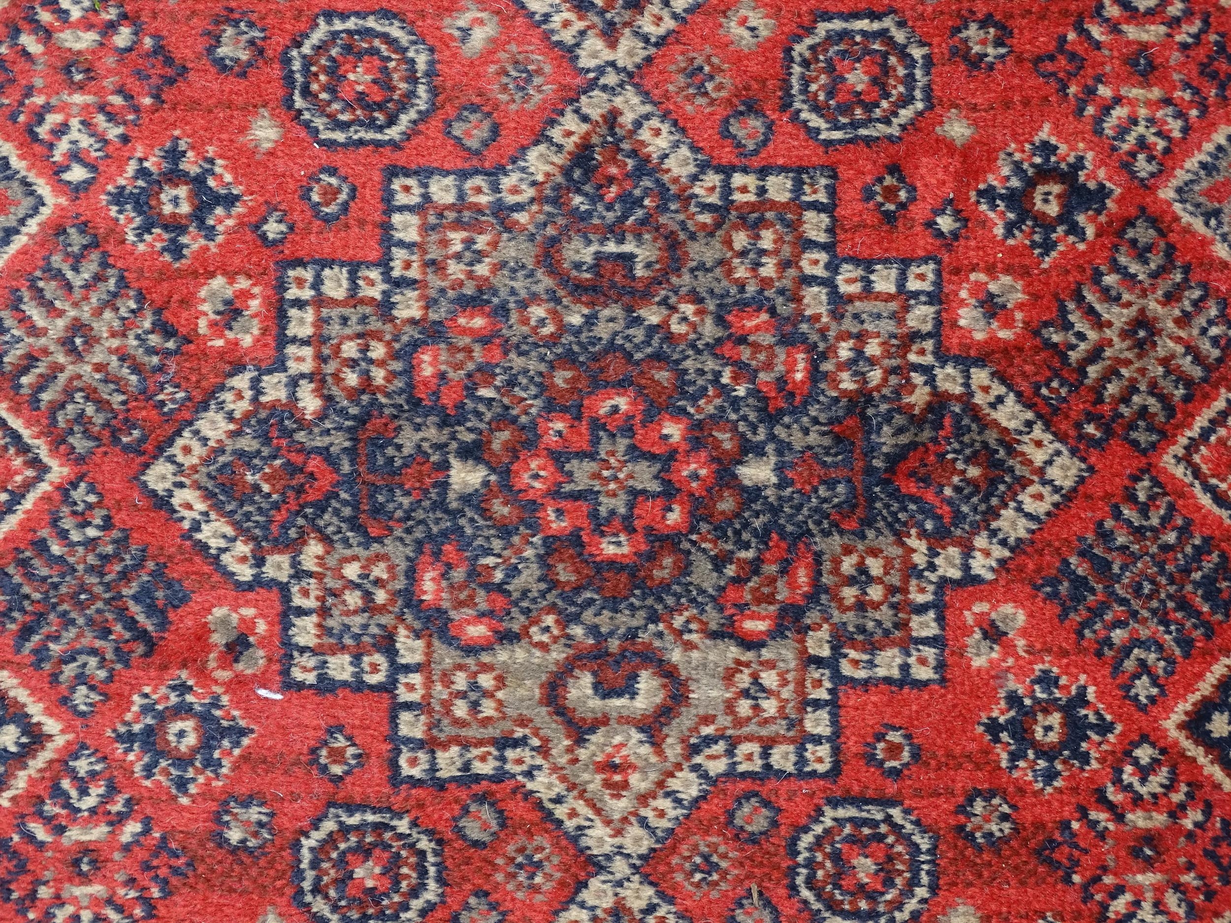 Carpet / Rug : A red ground runner with repeating motifs to centre, bordered by geometric banding. - Image 6 of 8