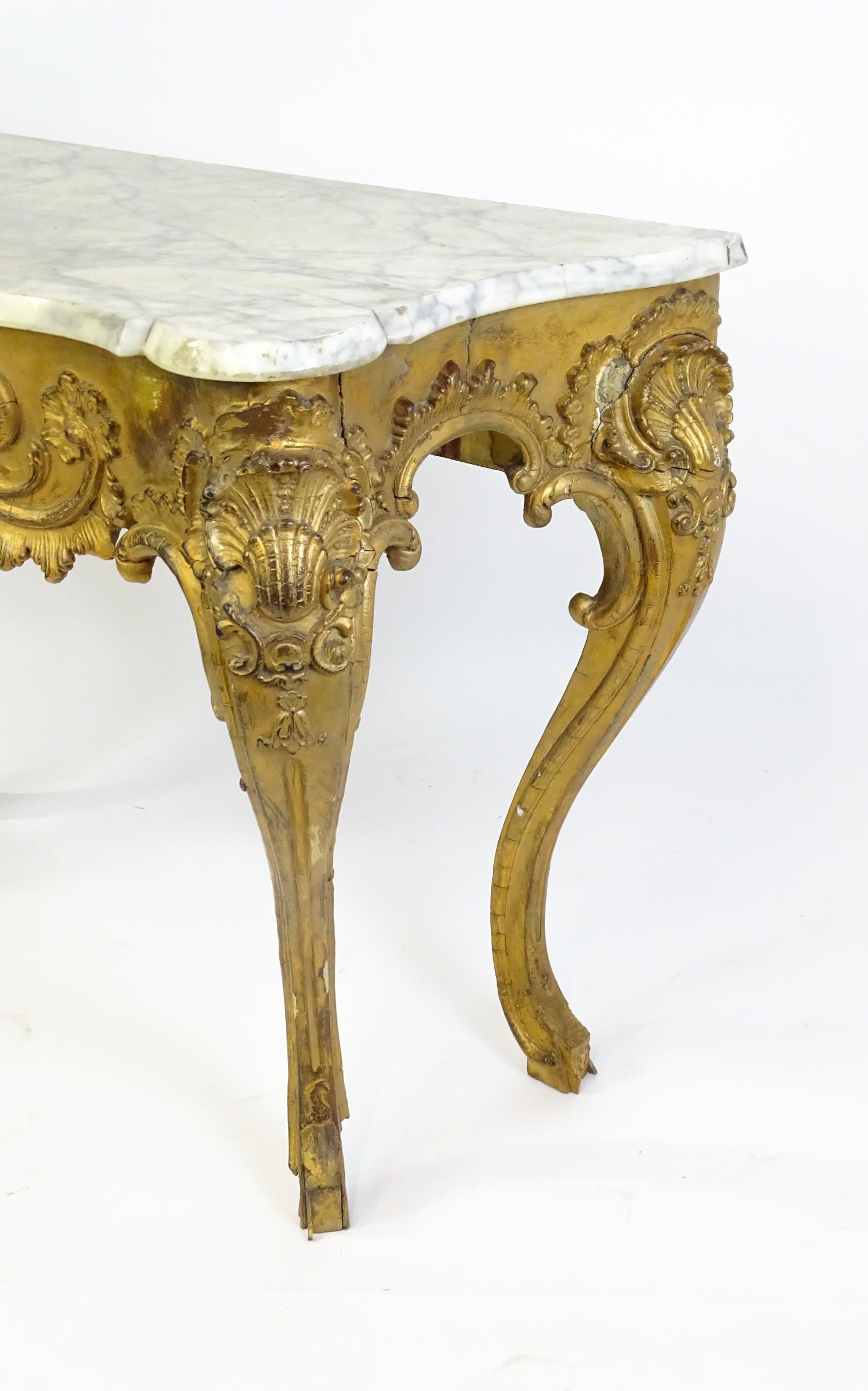 A 19thC marble topped table with a gesso and giltwood moulded base, decorated with shells, - Image 7 of 8