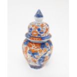 An Oriental ginger jar decorated in the Imari palette with flowers and foliage. Approx. 7 1/2"