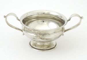 A silver twin handled pedestal bowl hallmarked Birmingham 1934, maker S. Blanckensee & Sons Ltd.