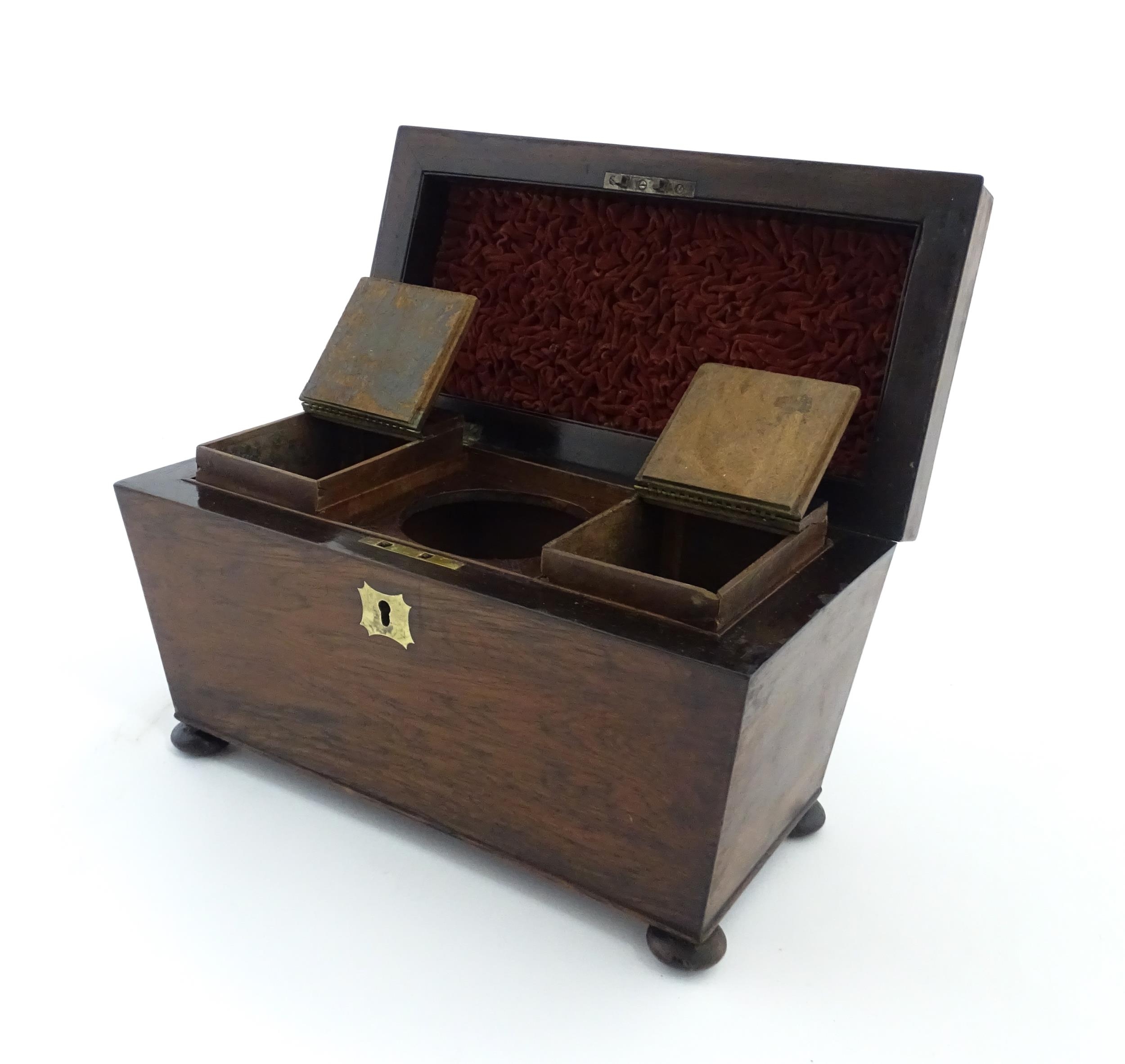 A 19thC rosewood tea caddy of sarcophagus form with four squat bun feet. The interior with two - Image 13 of 15
