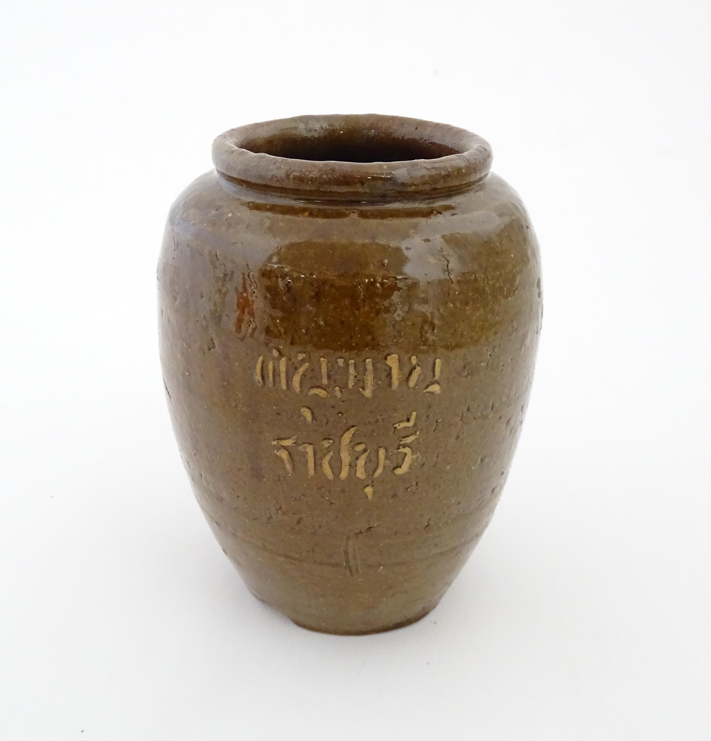 A stoneware vase / pot of tapering form with script detail. Approx. 6 1/4" high Please Note - we