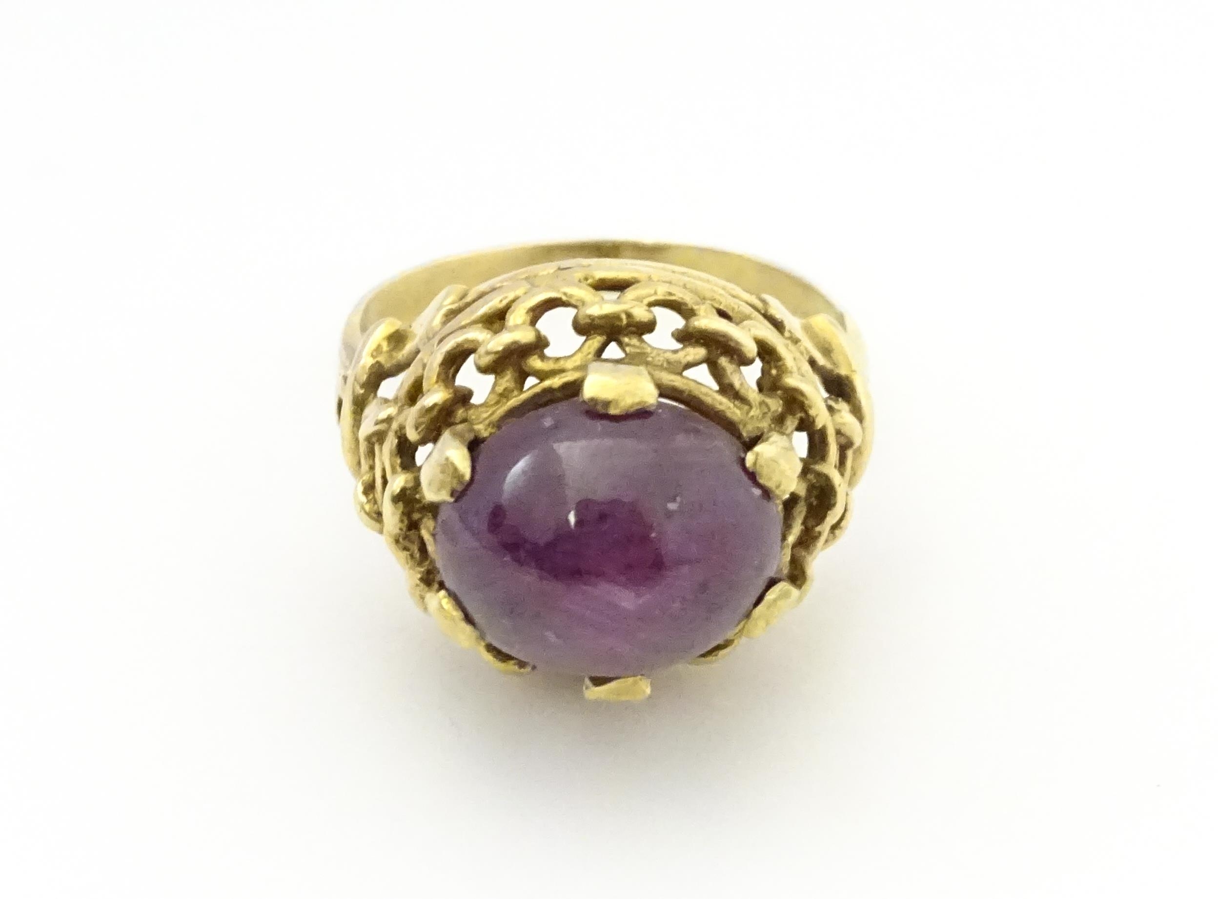 A 9ct gold ring set with ruby cabochon. Ring size approx. O Please Note - we do not make reference