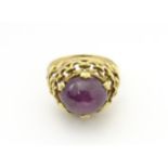 A 9ct gold ring set with ruby cabochon. Ring size approx. O Please Note - we do not make reference