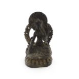 An Asian carved soapstone model of a seated deity on a stylised lotus. Approx. 14 1/2" high Please