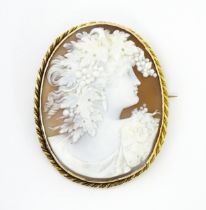 A large cameo brooch with carved cameo to centre depicting bacchanalian figure within a yellow metal