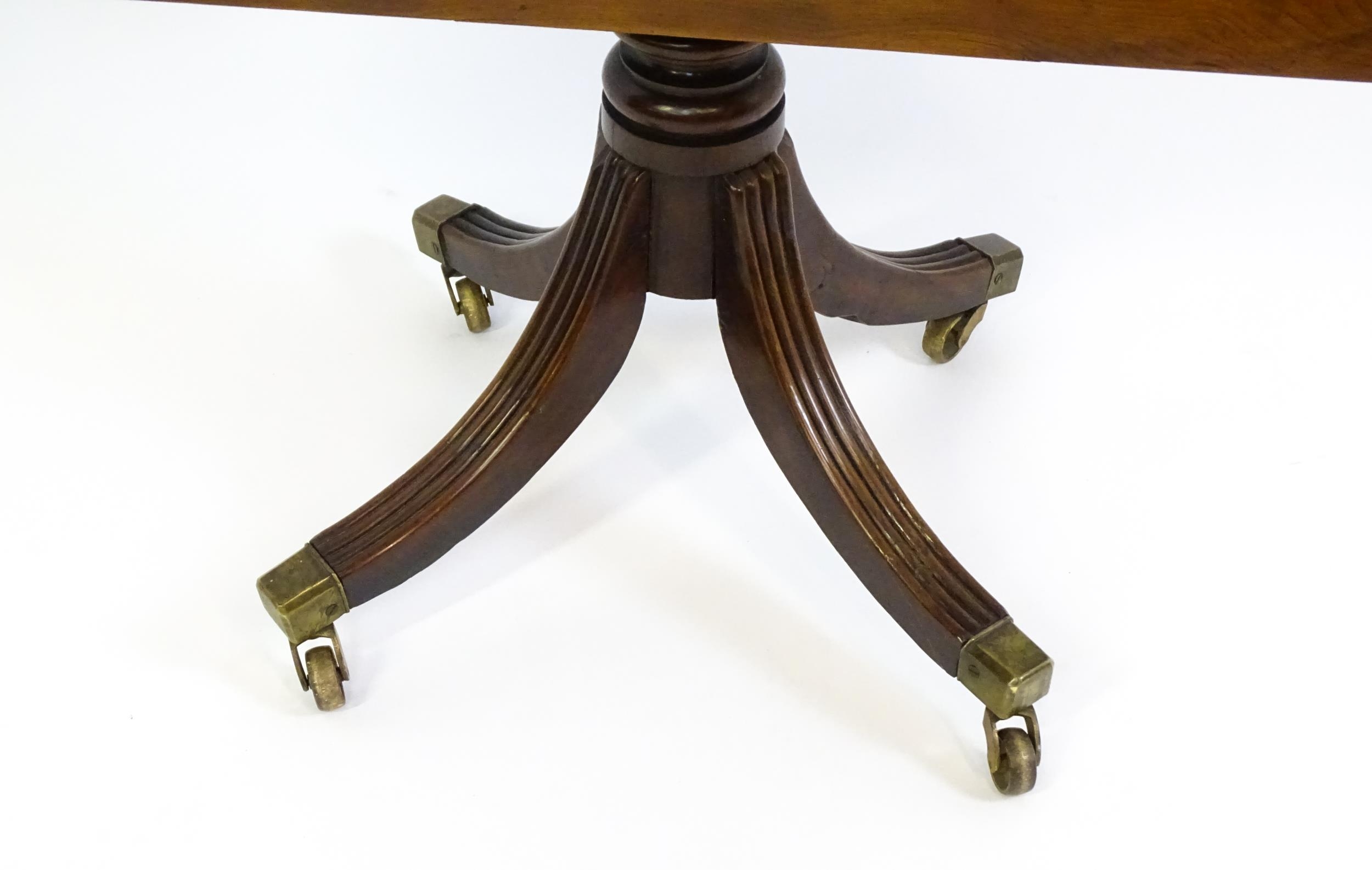 A 19thC tilt top occasional table with yew wood planked top above a reeded mahogany pedestal and - Image 10 of 13
