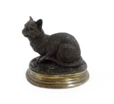 A 20thC cast bronze model of a seated cat after Pierre Jules Mene. Cast signature Mene to base.