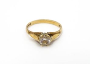 A 9ct gold ring set with white stone solitaire. Ring size approx. N Please Note - we do not make